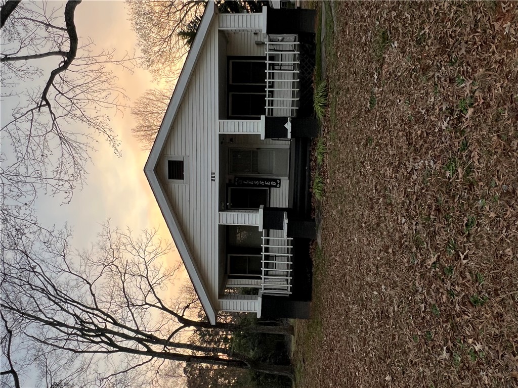 521 Calhoun Shores Parkway Calhoun Falls, SC 29628 - Photo 38 of 39 This charming home offers a welcoming facade with a classic porch and natural surroundings.