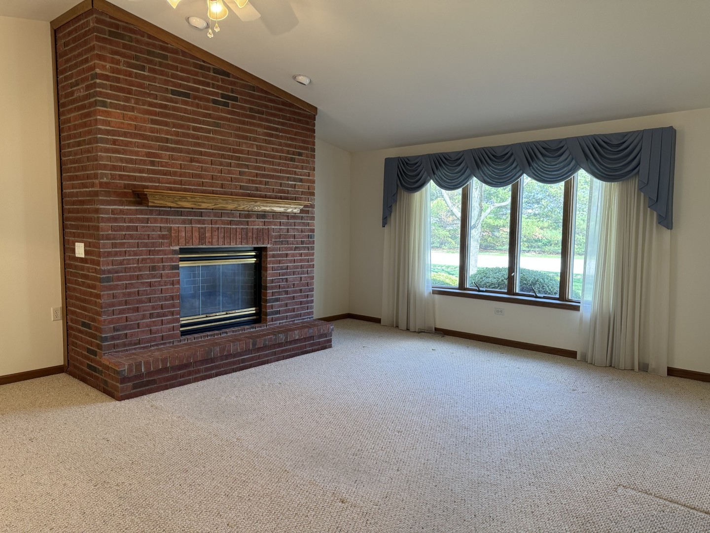 2800 Becker Drive Peru, IL 61354 - Photo 12 of 23 a view of an empty room with a fireplace and a window