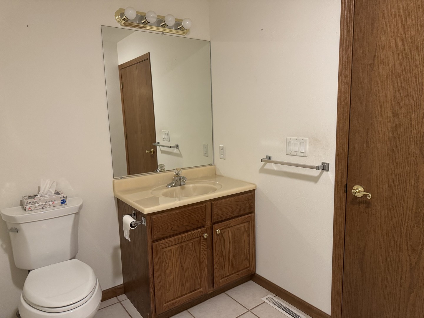 2800 Becker Drive Peru, IL 61354 - Photo 18 of 23 a bathroom with a toilet sink vanity and mirror