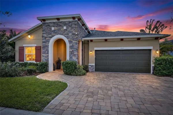a front view of a house with a garden