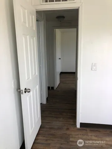 a view of a hallway with wooden floor