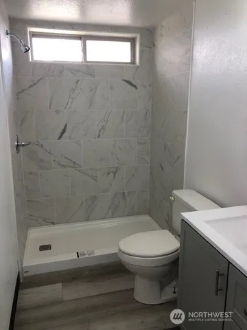 a bathroom with a toilet sink and mirror