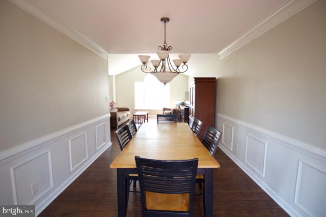 17 Ridgeway Road Stafford, VA 22556 - Photo 8 of 24 a dining room with wooden floor a chandelier a wooden table and chairs