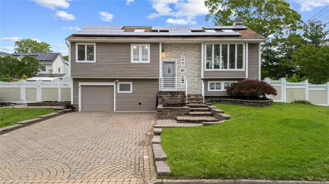 a front view of a house with a garden