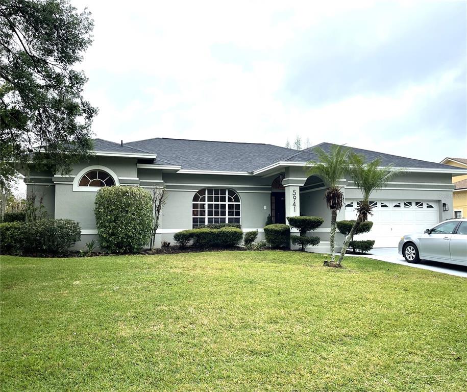 a view of a house with a yard and sitting area