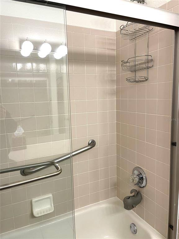 5941 Velvet Loop Lakeland, FL 33811 - Photo 25 of 61 a bathroom with a shower and a bath tub