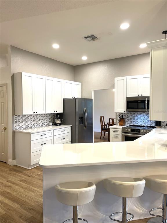 5941 Velvet Loop Lakeland, FL 33811 - Photo 28 of 61 a kitchen with refrigerator and chairs