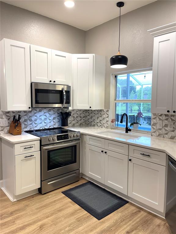 5941 Velvet Loop Lakeland, FL 33811 - Photo 31 of 61 a kitchen with a sink stove and microwave