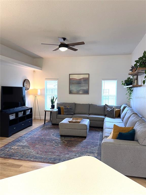 5941 Velvet Loop Lakeland, FL 33811 - Photo 35 of 61 a living room with furniture and a flat screen tv