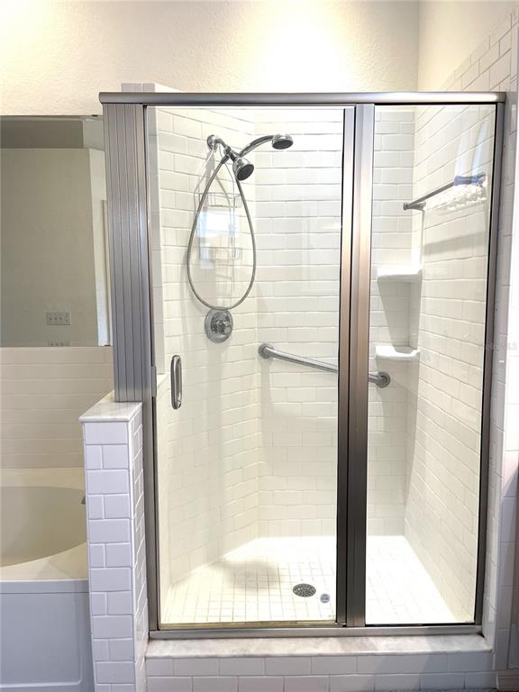 5941 Velvet Loop Lakeland, FL 33811 - Photo 42 of 61 a bathroom with a glass shower door and a window
