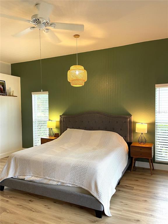 5941 Velvet Loop Lakeland, FL 33811 - Photo 49 of 61 a bedroom with a bed and a chandelier