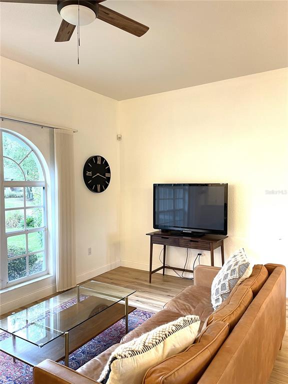 5941 Velvet Loop Lakeland, FL 33811 - Photo 8 of 61 a living room with couch and a flat screen tv