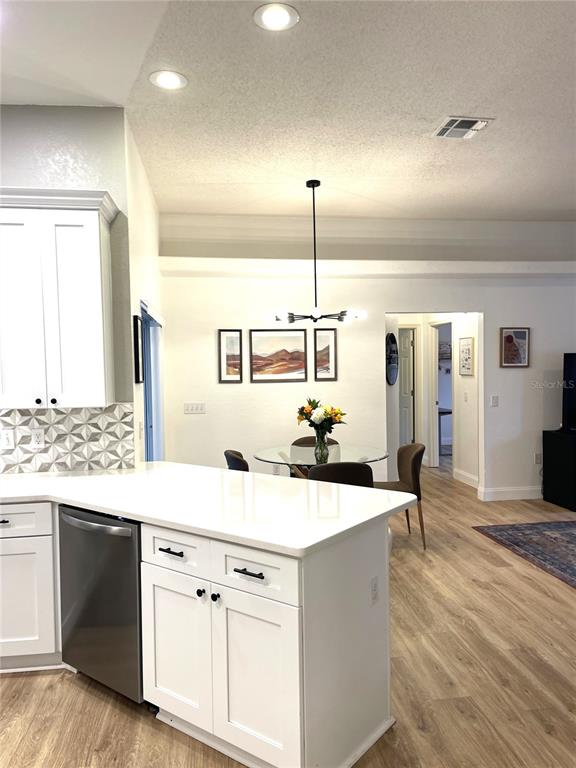 5941 Velvet Loop Lakeland, FL 33811 - Photo 9 of 61 a kitchen with kitchen island a stove a sink and wooden floor