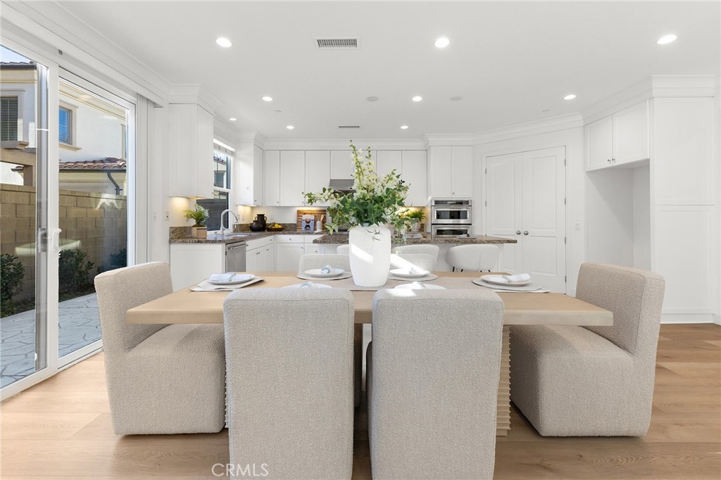 112 Velvetleaf Irvine, CA 92620 - Photo 11 of 51 a dining room with furniture a potted plant and kitchen view