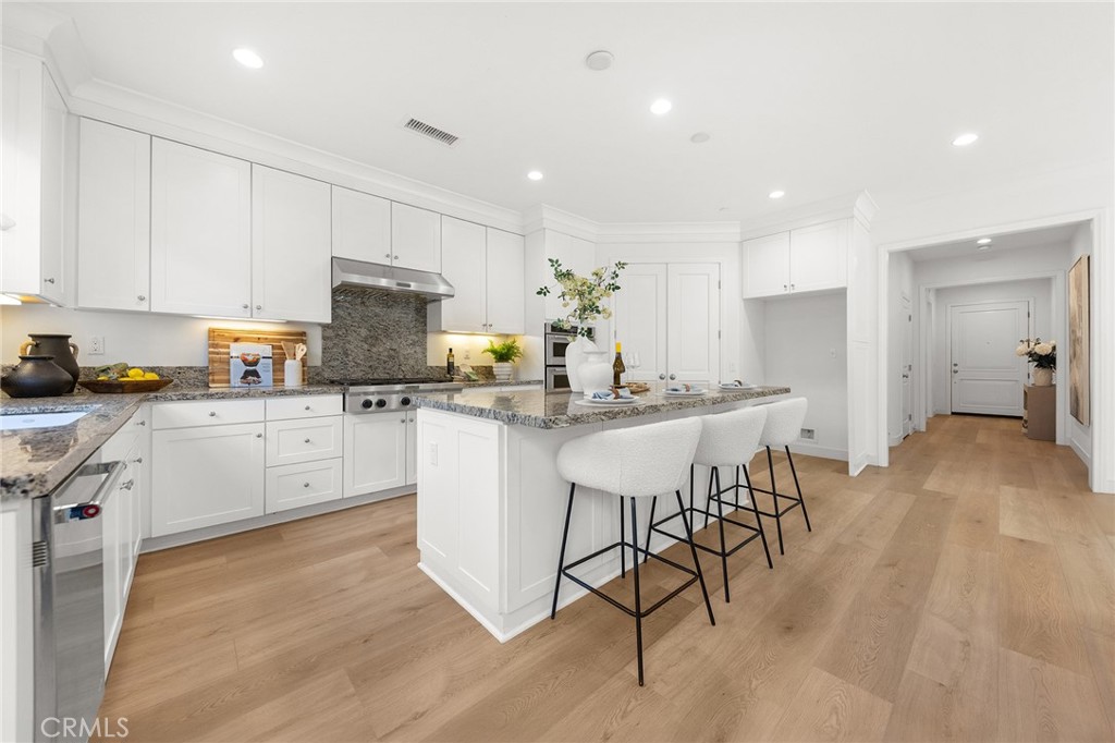 112 Velvetleaf Irvine, CA 92620 - Photo 13 of 51 a kitchen with a sink white cabinets and stainless steel appliances
