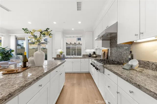 a kitchen with counter top space a sink cabinets and stainless steel appliances