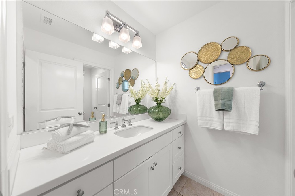 112 Velvetleaf Irvine, CA 92620 - Photo 22 of 51 a bathroom with a sink and a mirror