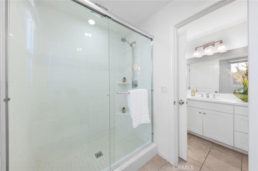 112 Velvetleaf Irvine, CA 92620 - Photo 23 of 51 a bathroom with a shower sink and mirror