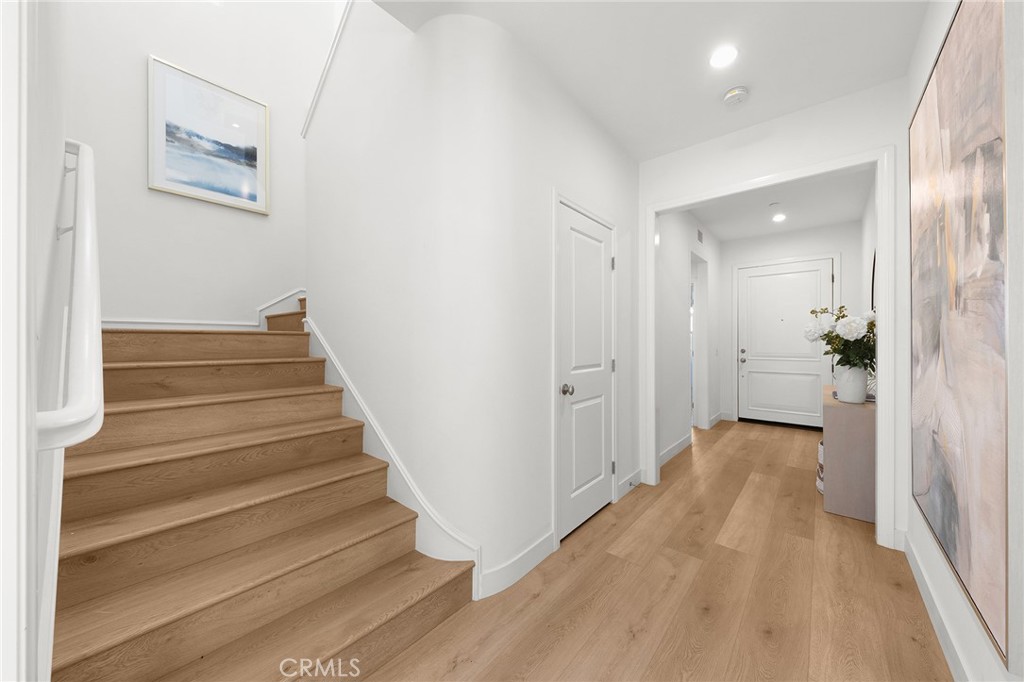 112 Velvetleaf Irvine, CA 92620 - Photo 24 of 51 a view of a hallway with wooden floor and stairs
