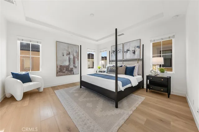 a bedroom with a bed mirror and window