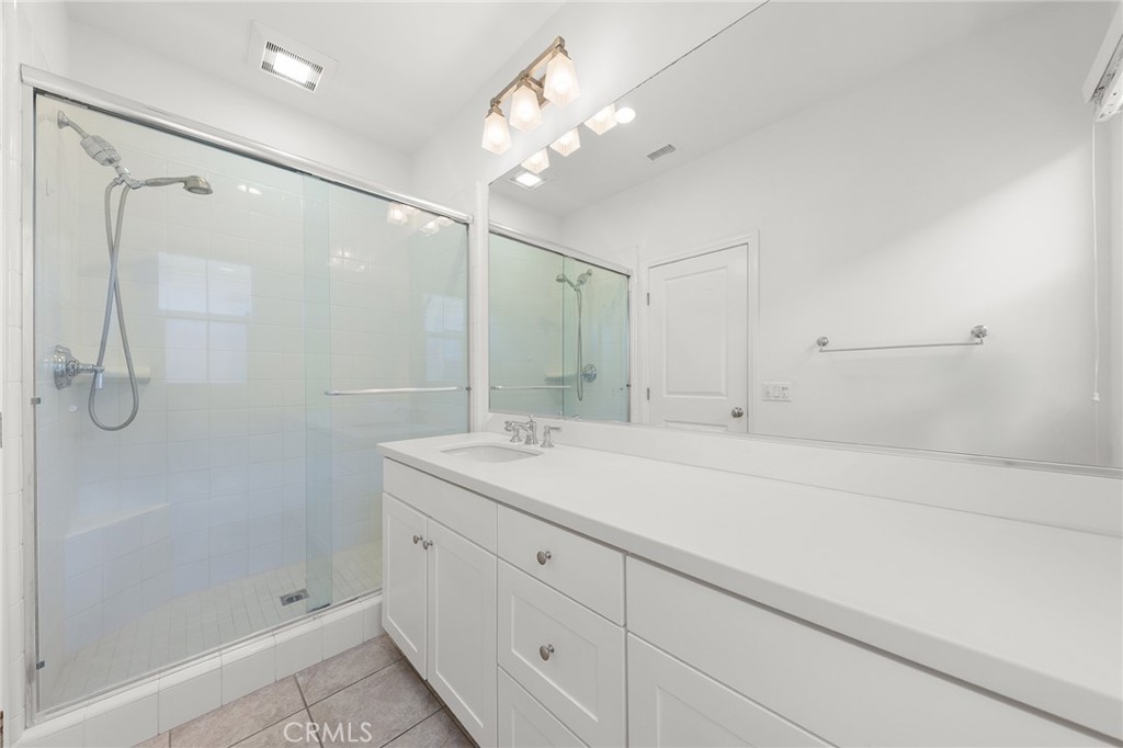 112 Velvetleaf Irvine, CA 92620 - Photo 38 of 51 a bathroom with a shower sink vanity and mirror