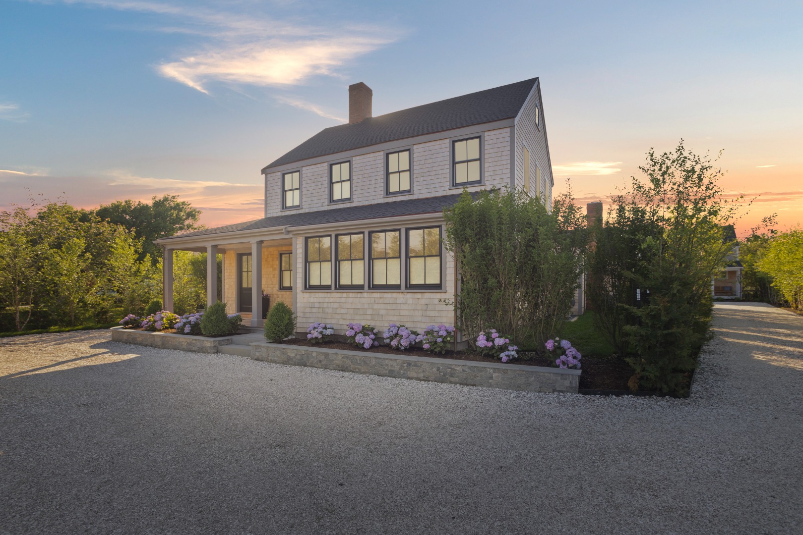 71 Fairgrounds Road Nantucket, MA 02554 - Photo 1 of 37 a front view of a house with a garden