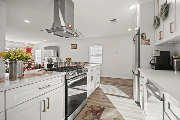 a kitchen with a stove a sink and a refrigerator
