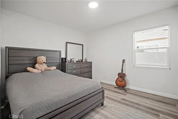 a bedroom with a bed and wooden floor