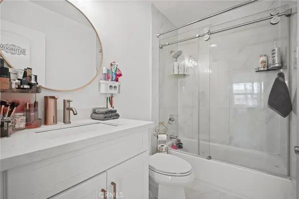 a bathroom with a sink mirror vanity and toilet