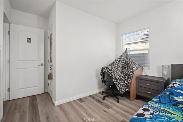 a bedroom with furniture and a window