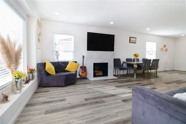a living room with furniture fireplace and a flat screen tv