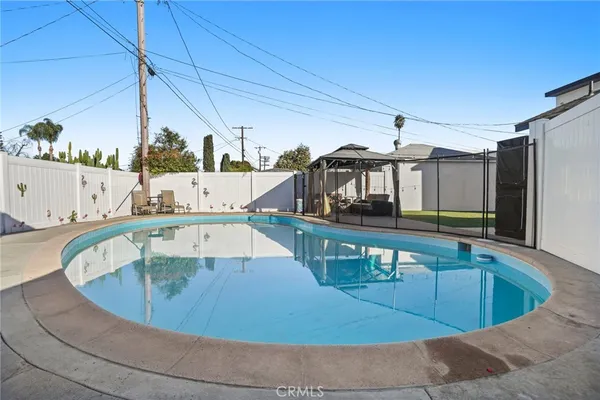 a view of a swimming pool with an outdoor seating