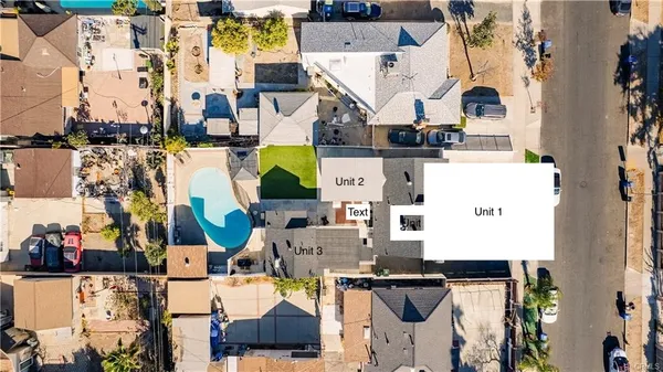an aerial view of a residential houses with outdoor space