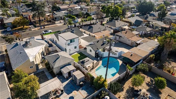 an aerial view of a houses with yard