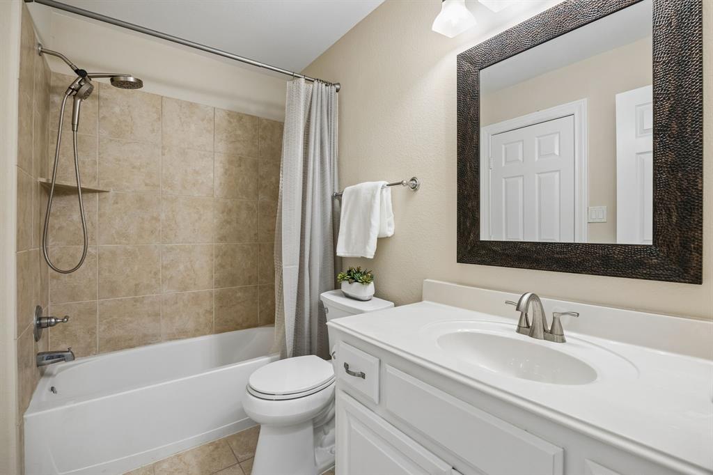 1011 Three Rivers Drive Prosper, TX 75078 - Photo 17 of 27 a bathroom with a sink toilet and shower