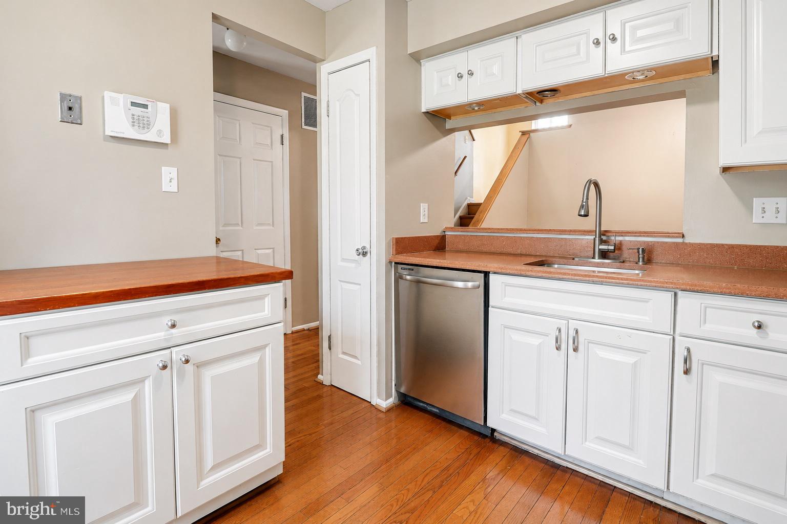 9054 Canterbury Riding, Unit 147 Laurel, MD 20723 - Photo 3 of 15 a kitchen with white cabinets and a sink