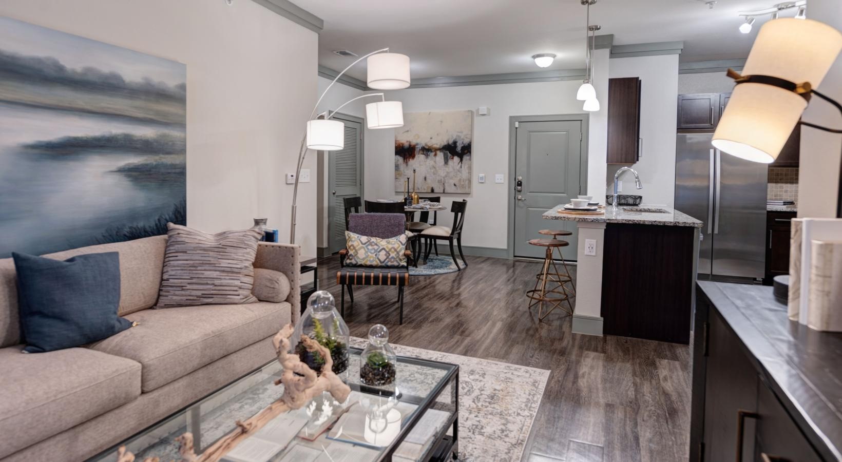 a living room with furniture and wooden floor