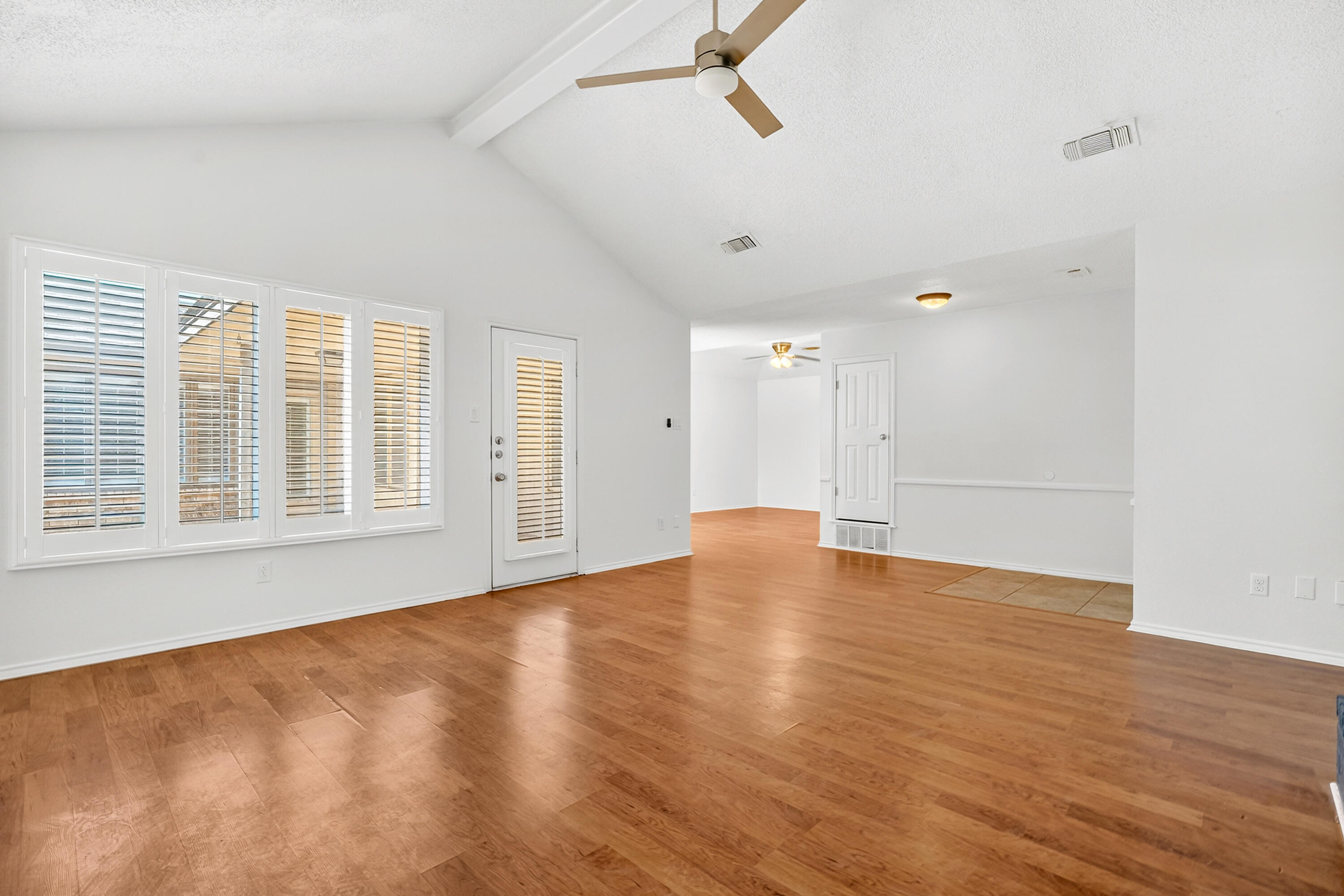 5221 84th Street Lubbock, TX 79424 - Photo 6 of 26 a view of empty room with wooden floor and fan