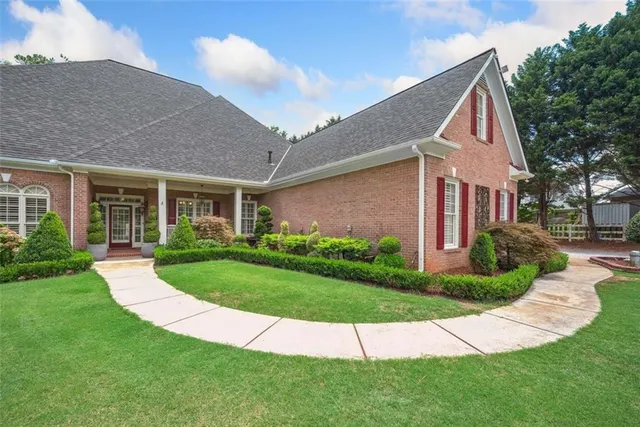 a view of a house with a yard and plants