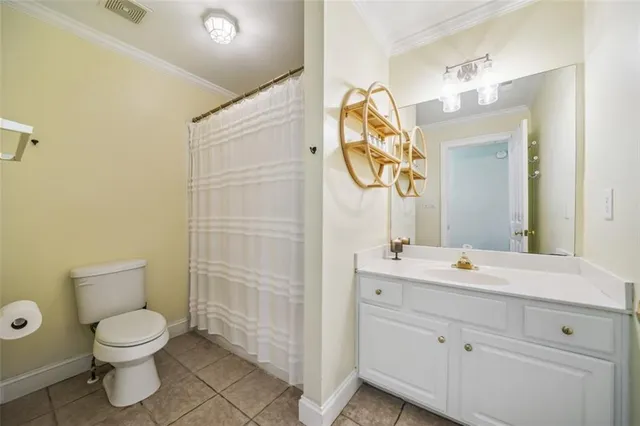 a bathroom with a toilet sink vanity and mirror