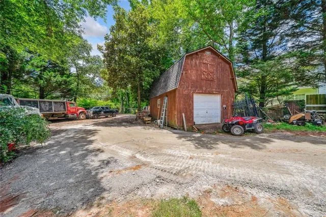 a view of a parked car with large trees