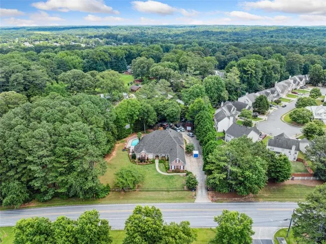an aerial view of a house with yard and outdoor seating