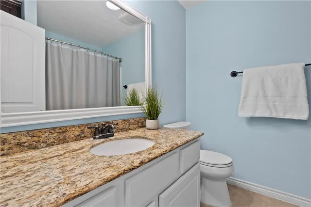 a kitchen with granite countertop stainless steel appliances a refrigerator stove and sink