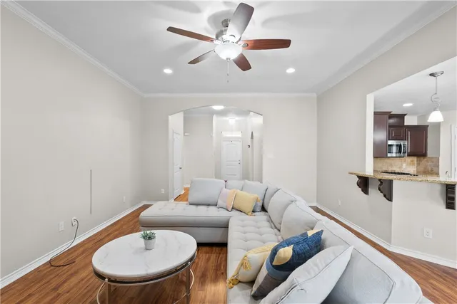a living room with furniture and a chandelier