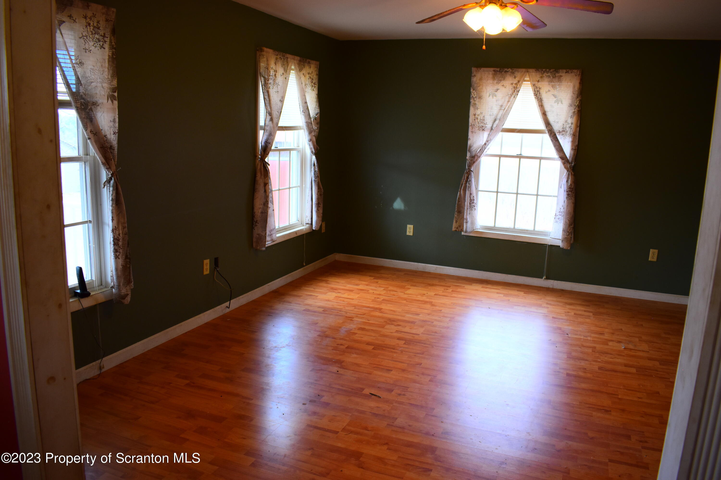 42 South Lott Road Meshoppen, PA 18630 - Photo 19 of 76 an empty room with wooden floor and windows