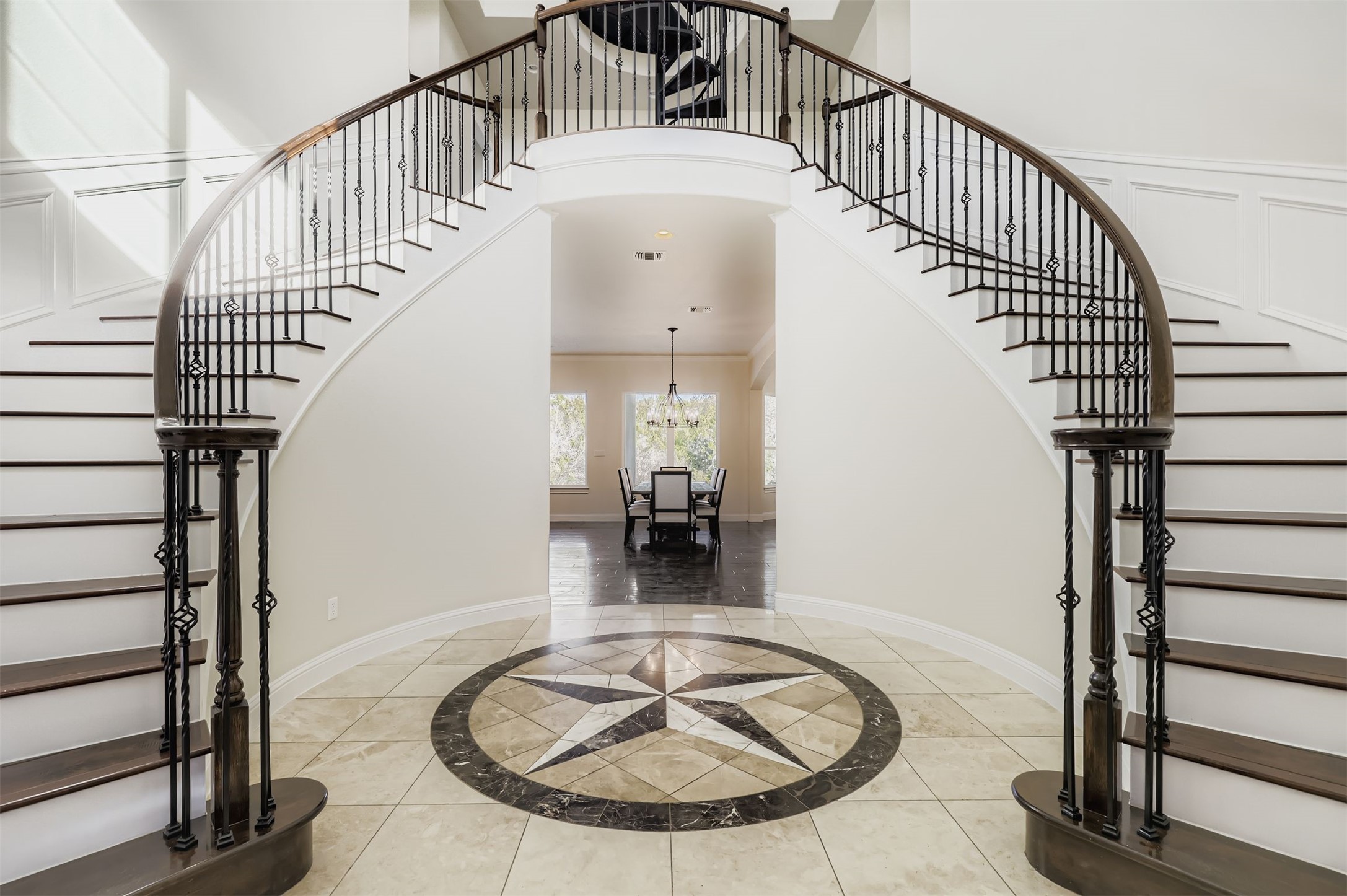 1415 Roaring Fork Leander, TX 78641 - Photo 2 of 39 Three story entry flanked by double staircase, inlaid floor details, a high ceiling, and a grand chandelier