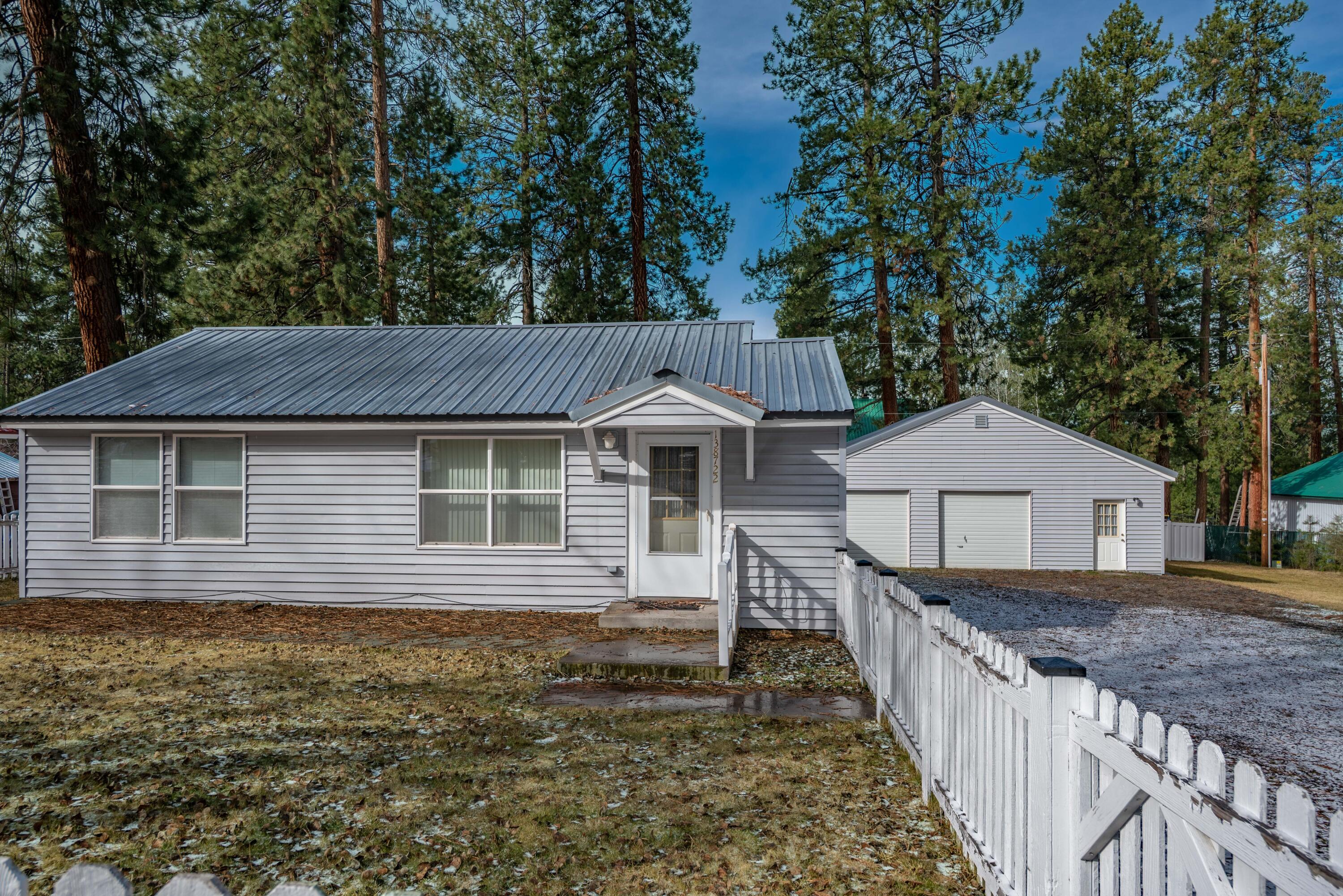 138722 Rhododendron Street Gilchrist, OR 97737 - Photo 32 of 36 a front view of a house with yard