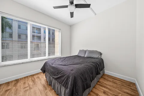 a bedroom with a bed and a window