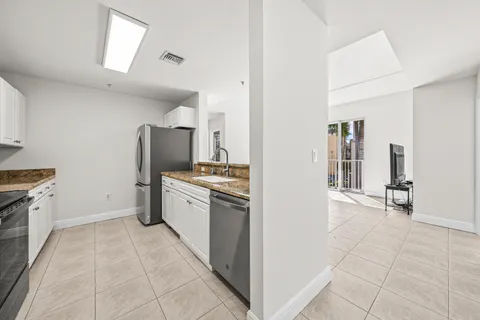 a large kitchen with a stove refrigerator and tub
