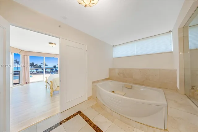 a bathroom with a bathtub and shower